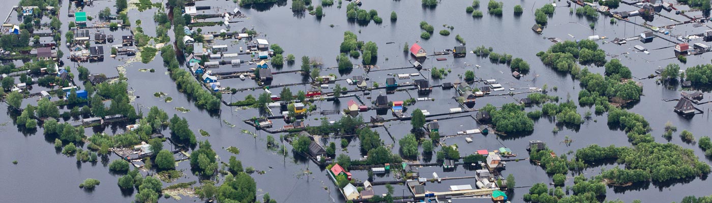 An aerial view of flooded houses.