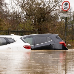 two cars submerged under flood water 