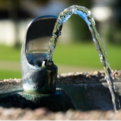 Close up of an outdoor, stainless steel water faucet