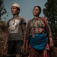 Two Nepalese people staring into distance 