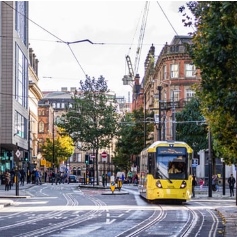 tram going across the tracks in Manchester city centre 
