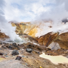 Steam rising from a volcanic rock formation 