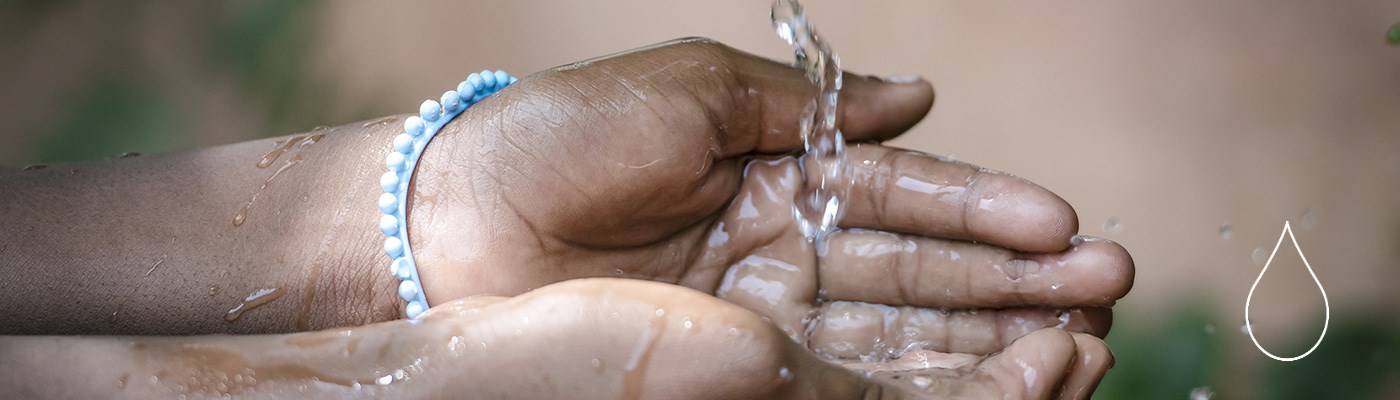 water running in a young girl's hands