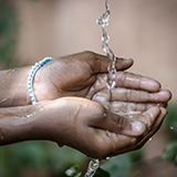 water running through a child's hands