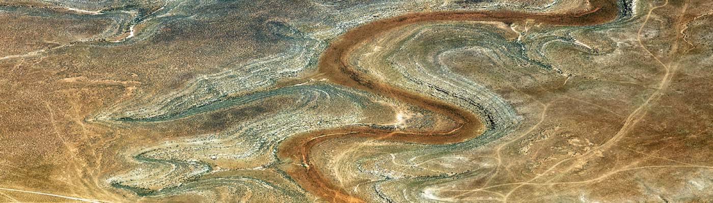 Aerial view of a river snaking through a desert