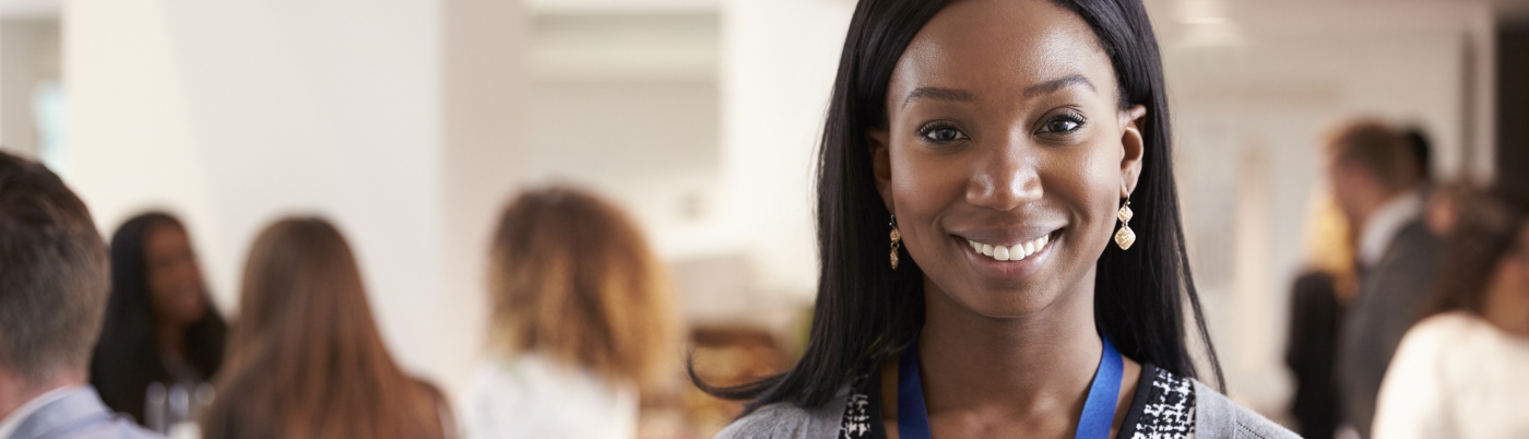 Female delegate at conference smiling to camera