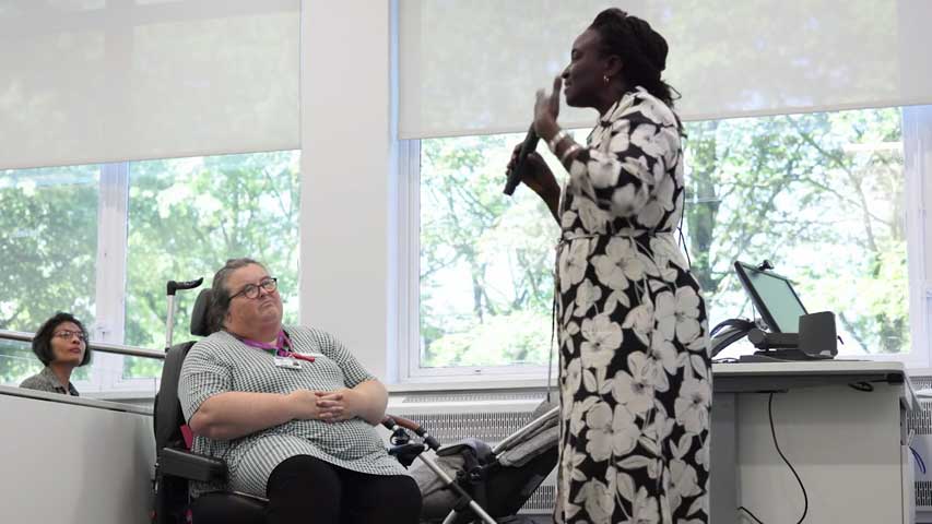 Photo from a presentation with a speaker and listeners